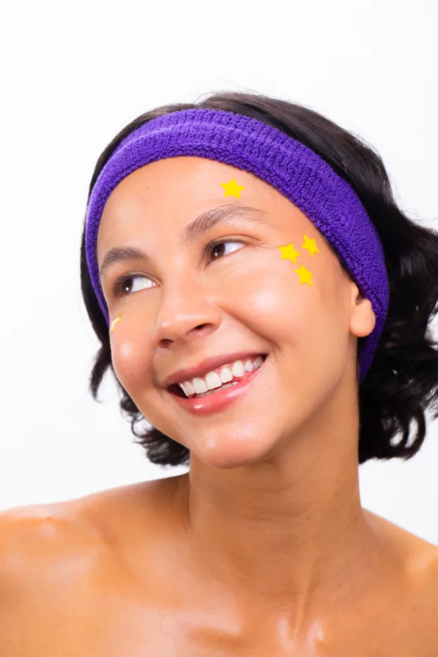 Sofia smiling in a purple headband with star stickers
